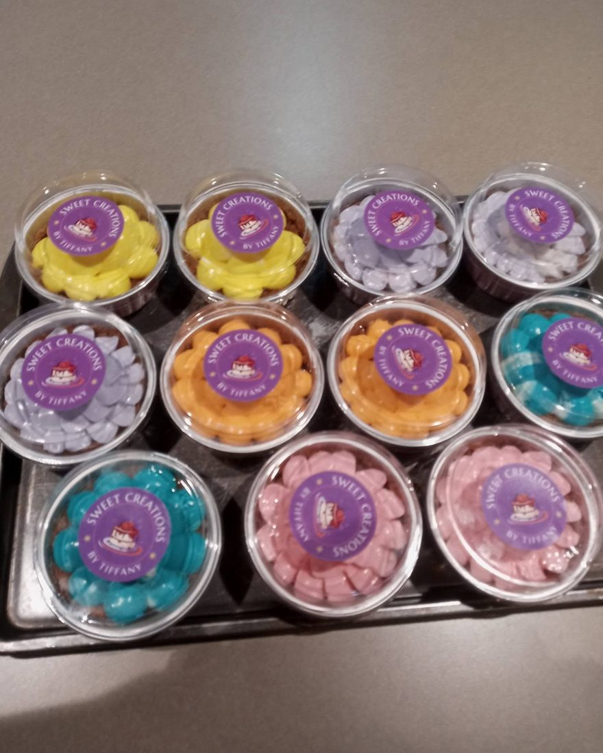 Trays of Sweet Creations by Tiffany dessert cups, each labeled with her own logo in cheerful colors