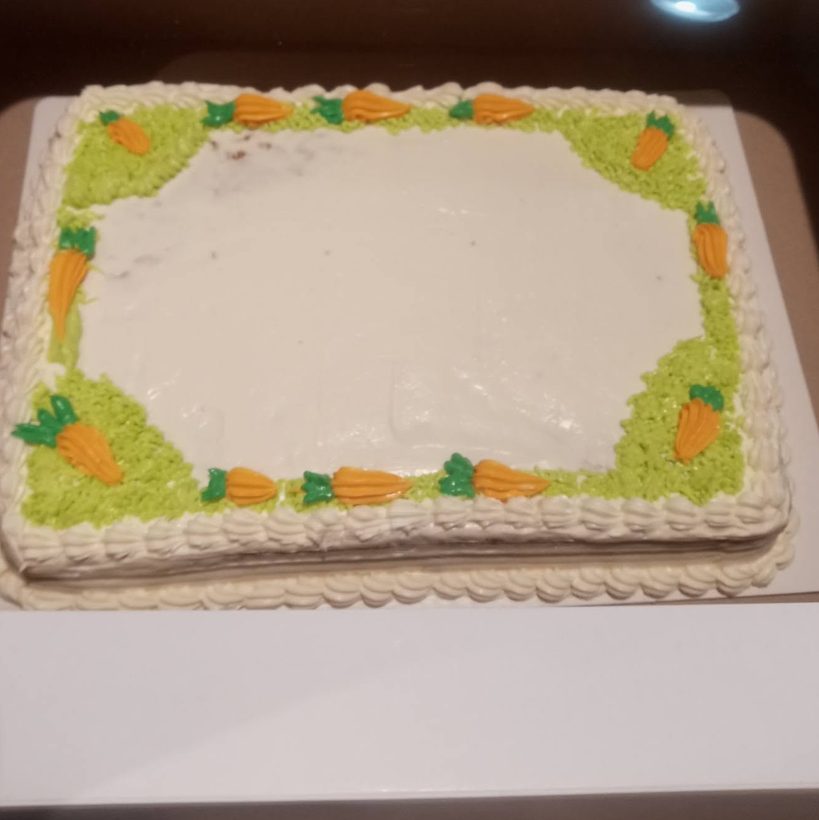Carrot cake with cream cheese frosting and piped carrots